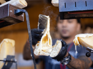 A Big Cheese Vendor prepares a sandwich