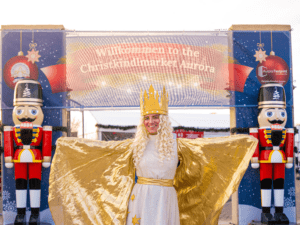 The Christkind standing at the entrance of the Aurora Christkindlmarket