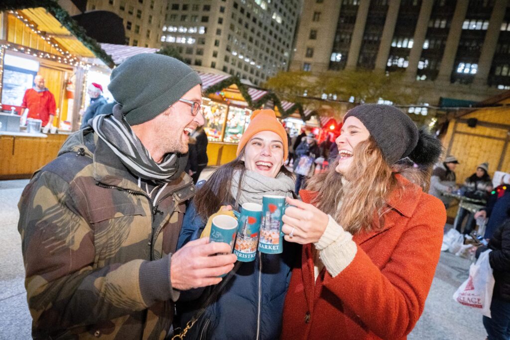Christkindlmarket Friends cheering with mugs