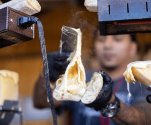 A Big Cheese Vendor prepares a sandwich